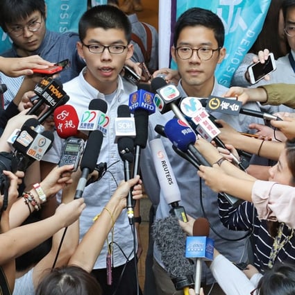 Joshua Wong (left) and Nathan Law speak to the media outside the Court of Final Appeal in Central after being released on bail. Photo: Felix Wong