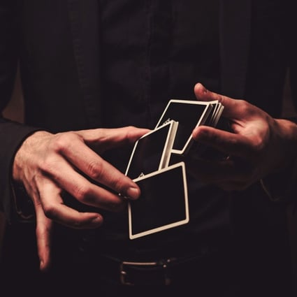 Watch closely – a magician’s hands move in mysterious ways with a deck of cards.