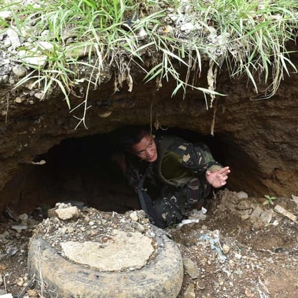 A soldier inspects a tunnel connected to the city's underground drainage system, used by militants as cover during the height of battle with government troops. Photo: AFP