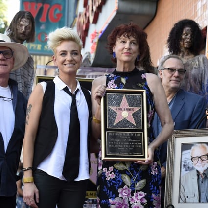 Suzanne Desrocher, centre, the widow of the late director George A. Romero, is joined by actor Malcolm McDowell, foreground from left, Romero's daughter Tina, special effects/make-up artist Greg Nicotero and director Edgar Wright during a ceremony awarding Romero with a star on the Hollywood Walk of Fame on Wednesday, October 25, 2017, in Los Angeles. Romero is the writer/director of the 1968 zombie film “Night of the Living Dead.” Photo: Invision/AP