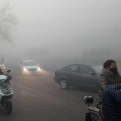 Road users make their way through heavy smog in Beijing on Friday morning. Photo: Handout