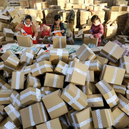 Package handlers prepare deliveries at a sorting centre in Lianyungang, Jiangsu province during the Singles’ Day online shopping festival last November. Photo: AFP