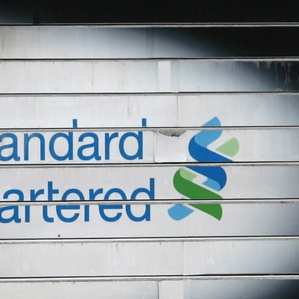 A woman walks down the stairs of the Standard Chartered headquarters in Hong Kong. Photo: Reuters