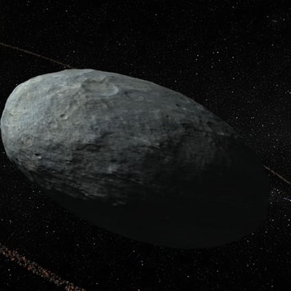 An artist’s rendering of the dwarf planet Haumea and its ring system, beyond Neptune. The discovery of a ring around an unassuming mini planet in our solar system debunks the theory that only giant planets have such features. Photo: AFP/Nature Publishing Group
