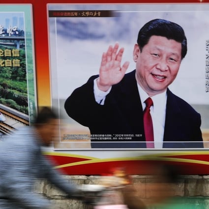 People ride tricycle carts past a poster of Chinese President Xi Jinping, along a street in Beijing, Thursday, October 26, 2017. Photo: AP
