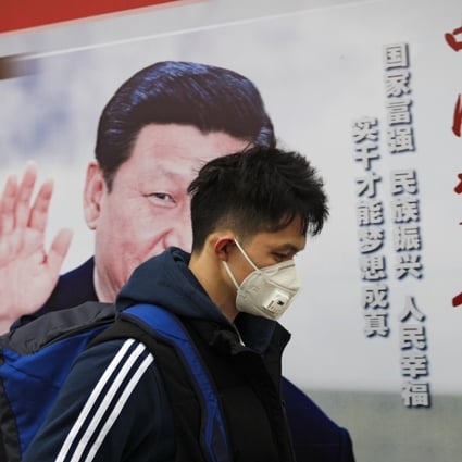 A man wearing a mask for protection against pollution walks by a poster featuring President Xi Jinping, in Beijing on October 26. Xi, considered China’s most powerful and influential leader in decades, has made environmental clean-up and sustainability central to his agenda. Photo: AP