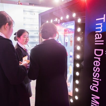 An electronic screen at a T-Mall exhibition showcases online fitting during the Singles’ Day in Shanghai on November 11, 2017. Photo: AFP