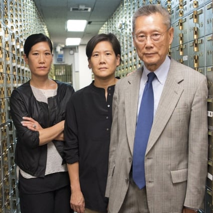 From left: Vera Sung, Jill Sung and their father Thomas Sung in the safety deposit box area of Abacus Federal Savings Bank in New York's Chinatown. Photo: Sean Lyness, courtesy Kartemquin Films