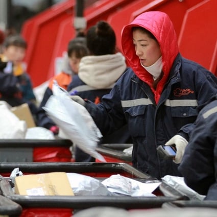 Employees scan boxes and parcels at the logistic centre of an express delivery company, after the Singles’ Day online shopping festival, in Harbin, Heilongjiang province. Photo: Reuters