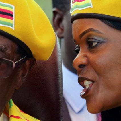 Zimbabwean first lady Grace Mugabe speaks into her husband President Robert Mugabe’s ear during a ruling party rally. Photo: Reuters
