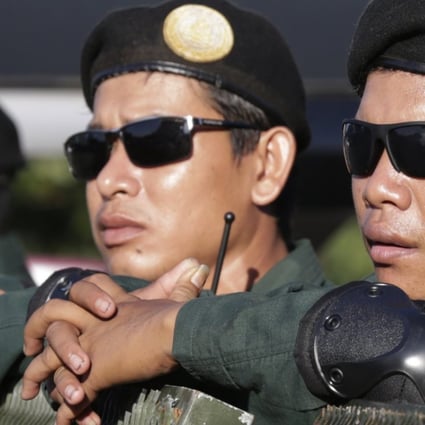 Cambodian police officers stand guard on a street near the Supreme Court in Phnom Penh. Photo: EPA