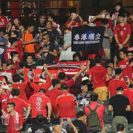 Young Hong Kong soccer fans turn their backs on the pitch, with some holding up an independence banner, as the national anthem plays before a 2019 Asian Cup qualification match with Malaysia, on October 10. Photo: Dickson Lee