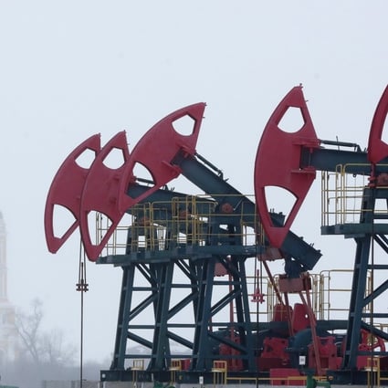 A worker passes a line of oil pumping jacks in the Bashneft oilfield outside the village of Nikolo-Beryozovka near Neftekamsk in Russia. The recent acquisition spree by Chinese firms in Russian energy and commodities companies is set to continue into next year, according to a senior banker at the Moscow-based, Russian state-backed investment firm VTB Capital. Photo: Bloomberg