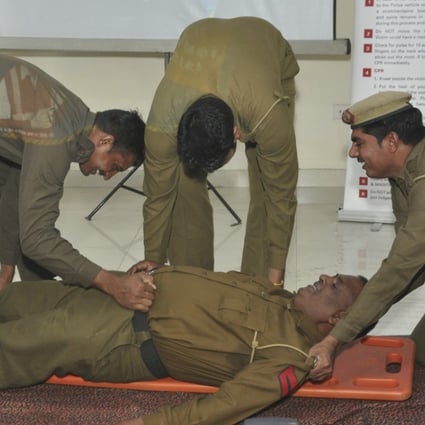 Participants learn how to use a spinal board during a first aid course run by the SaveLIFE Foundation in New Delhi. Photo: Amrit Dhillon