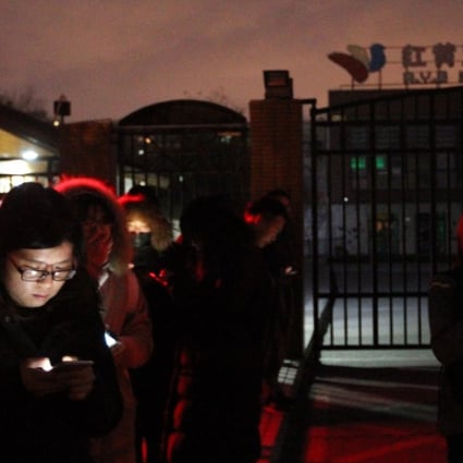 Media wait outside the RYB New World kindergarten in eastern Beijing on Thursday night. Photo: Simon Song