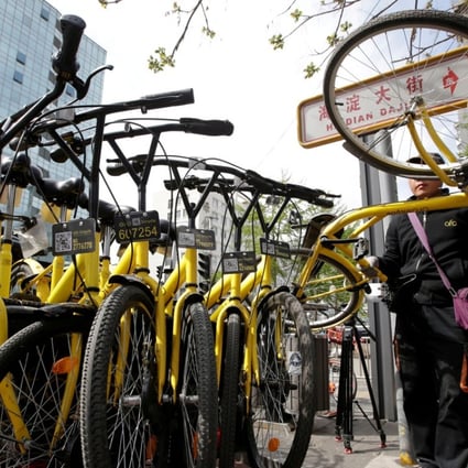 A staff member from Ofo gathers its shared bikes for use during the evening rush hour in Beijing. Ofo and competitor Mobike account for 95 per cent of the bike sharing market, leaving little room for others. Photo: Reuters