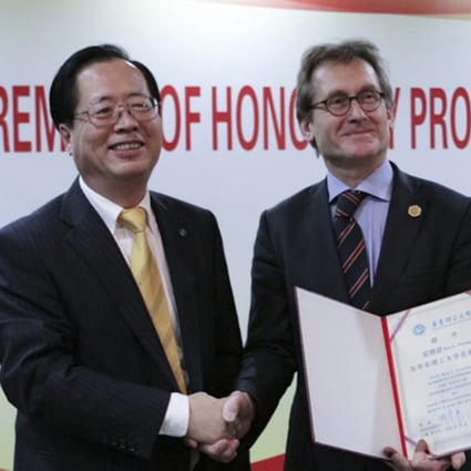 East China University of Science and Technology president Qu Jingping (left) congratulates chemist Bernard Feringa on his appointment as an honorary professor of the university earlier this month. Photo: East China University of Science and Technology