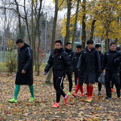 China’s under-20 squad traipses away from a friendly match after demonstrators staged a protest with Tibetan flags in Mainz, Germany. Photo: AP