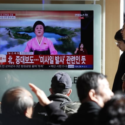 South Koreans watch a live TV report showing North Korea’s missile test announcement at a station in Seoul on Wednesday. Photo: EPA