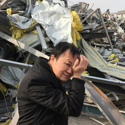 A migrant worker walks past buildings demolished following a citywide fire safety inspection in Daxing district, Beijing. Photo: Reuters