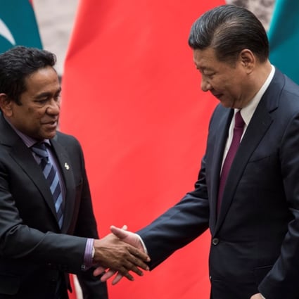 Abdulla Yameen Abdul Gayoom (left) shakes hands with Xi Jinping after signing deals at the Great Hall of the People in Beijing on Thursday. Photo: Reuters