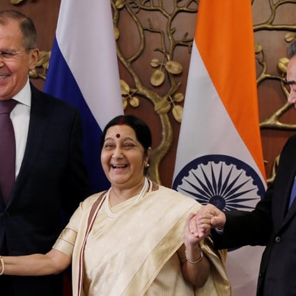 Indian Foreign Minister Sushma Swaraj (centre) smiles as she joins hands with Chinese Foreign Minister Wang Yi (right) and Russian Foreign Minister Sergey Lavrov ahead of their trilateral meeting in New Delhi on Monday. Photo: Reuters