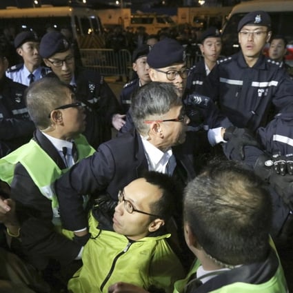 Legislative Council security staff and Hong Kong police began removing protesters from the demonstration zone late Monday evening. Photo: Felix Wong