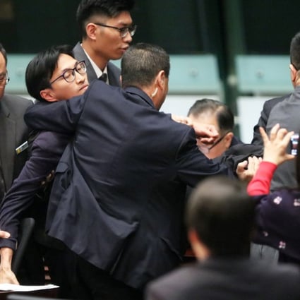 Lawmaker Eddie Chu Hoi-dick being carried out of the Legco chamber. Photo: Felix Wong