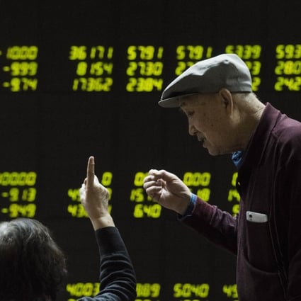 Investors look at screens showing stock market movements at a securities company in Beijing. Experts say China’s elderly can be particularly vulnerable to risky or even fraudulent investments, such as P2P online lending. Photo: AFP