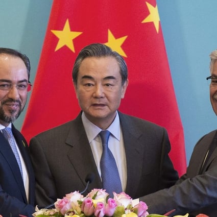 China's Foreign Minister Wang Yi (centre), Afghanistan's Foreign Minister Salahuddin Rabbani (left) and Pakistan's Foreign Minister Khawaja Muhammad Asif shake hands at the end of a joint press conference and after the first China-Afghanistan-Pakistan Foreign Ministers' Dialogue in Beijing. Photo: AFP
