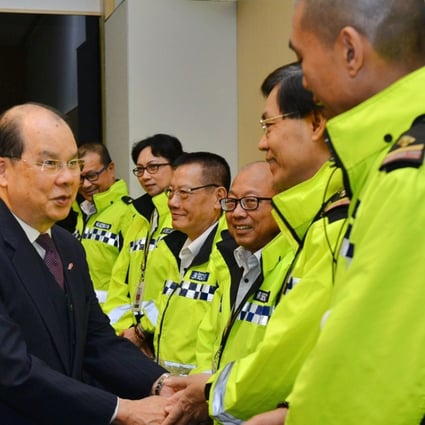 Chief Secretary Matthew Cheung speaks to security guards in a photo released by the government.