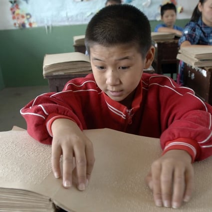 Children read Chinese Braille at a school for the blind in Hefei, Anhui province. Picture: AFP