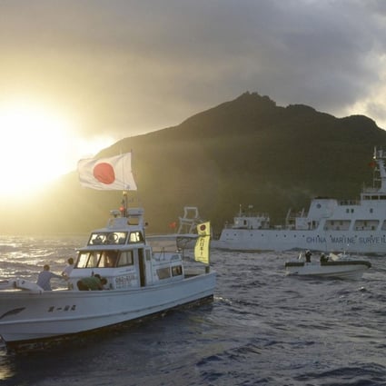 Japanese coast guard ships sail next to Chinese marine surveillance ships bear one of the disputed Diaoyu islands. Japanese names have been given to 34 underwater features in the disputed waters. Photo: Reuters