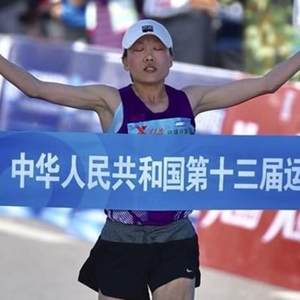 Wang Jiali crosses the finish line to win the women's marathon at the 2017 National Games. Photos: Xinhua