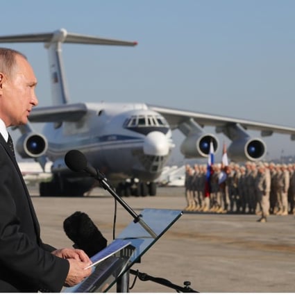 Russian President Vladimir Putin (left) visits the Khmeimim Air Base in Syria on December 11. Photo: EPA