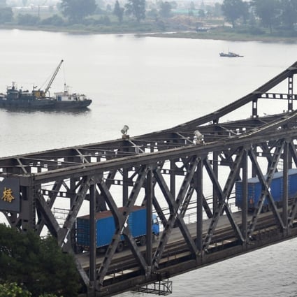 Trucks are seen driving across the Sino-Korean Friendship Bridge from China’s Dandong towards North Korea's Sinuiju in this photo taken in September 2017. China reported its imports from North Korea plunged 81.6 per cent in December. Photo: Kyodo