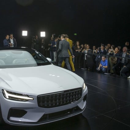 Attendees look at the Polestar 1 during its unveiling in Shanghai, China Tuesday Oct. 17, 2017. Volvo Cars' performance electric car brand, Polestar, unveiled a four-seat coupe in lightweight carbon fibre as its first model Tuesday, adding to competition in a market dominated until now by Tesla. Photo: Chinatopix via AP.
