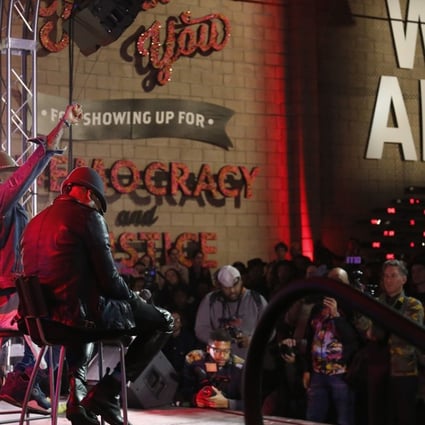 will.i.am, Taboo and apl.de.ap of The Black Eyed Peas address the crowd at Into Action in Los Angeles. Photo: TNS