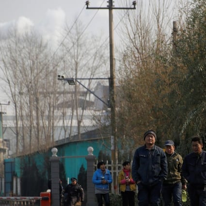 Smoke billows from a chimney as workers leave a factory in Gaoyi county, near Shijiazhuang, capital of northern China’s Hebei province and the country’s most polluted city in terms of PM2.5 readings in 2017. Photo: Reuters