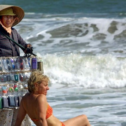 A vendor tries to sell sunglasses to a tourist in Nha Trang, Vietnam. Photo: AFP