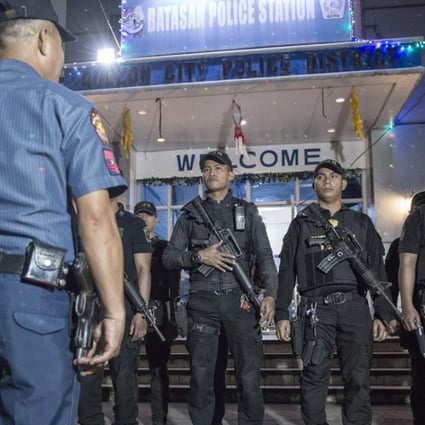 Armed police officers at Batasan Police Station 6, in Manila, prepare to mount an anti-drug roadblock on December 14, 2017. Pictures: Zigor Aldama