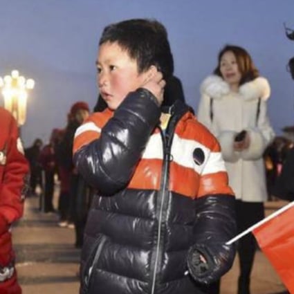 “Ice Boy” Wang Fuman, 8, attends the flag-raising ceremony in Tiananmen Square on Saturday with his sister Wang Fumei, 10. Photo: Baijiahao.baidu.com