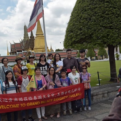 A group of Chinese tourists pose for a picture before visiting the Grand Palace in Bangkok. Photo: AFP