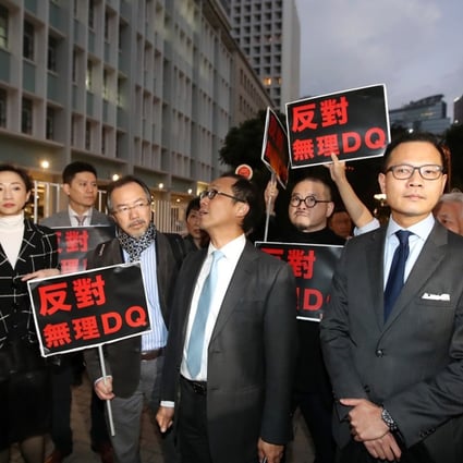 Pan-democrats waited outside justice secretary Teresa Cheng’s office to demand an explanation for why two pro-democracy activists had not yet been confirmed as candidates for the March 11 by-election. Photo: Edward Wong