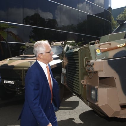 Australian Prime Minister Malcolm Turnbull inspects the Bushmaster military truck. Photo: EPA