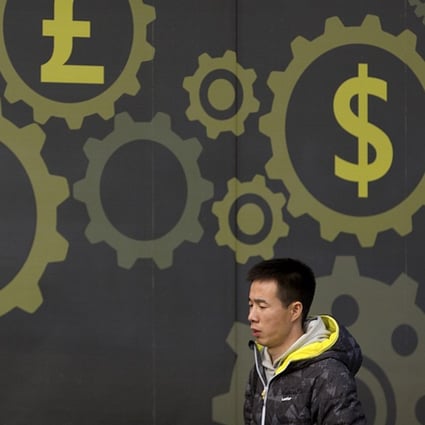 A weaker currency is seen as a major boost for exporting nations. A man walks past a display showing symbols for world currencies on the exterior of a bank in Beijing. Photo: AP