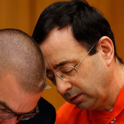 Former Michigan State University and USA Gymnastics doctor Larry Nassar with his defence lawyer Matt Newberg (L) during the sentencing phase in Eaton County Circuit Court on January 31, 2018 in Charlotte, Michigan. Prosecutors said at least 65 victims were to confront Nassar in court, in the last of three sentencing hearings for the disgraced doctor who molested young girls and women for two decades in the guise of medical treatment. Photo: AFP