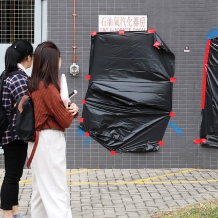 Graffiti on a building on the Baptist University campus is covered up. Young people and students have a right to express their opinions, and to speak out when they think something is wrong. But they need to do it within particular boundaries, with basic manners. Photo: K. Y. Cheng