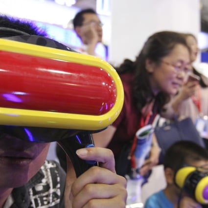 Visitors play VR video games at the 20th China Beijing International High-Tech Expo (CHITEC) opens in Beijing in June last year. Phioto: SCMP