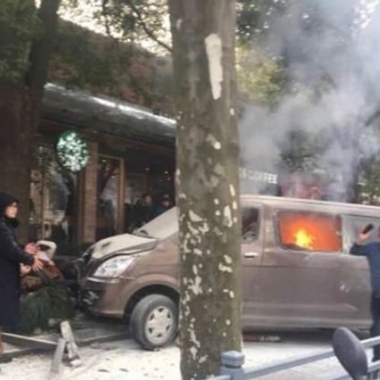 The vehicle was already on fire when it mounted the pavement and crashed into a fence outside a Starbucks outlet in the Huangpu district of Shanghai on Friday morning. Photo: Weibo